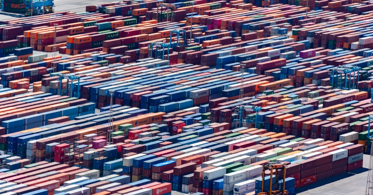 A bustling port with colorful cargo containers, aerial view showcasing global trade.